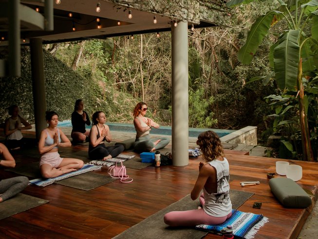 group of people in seated meditation on an outdoor patio