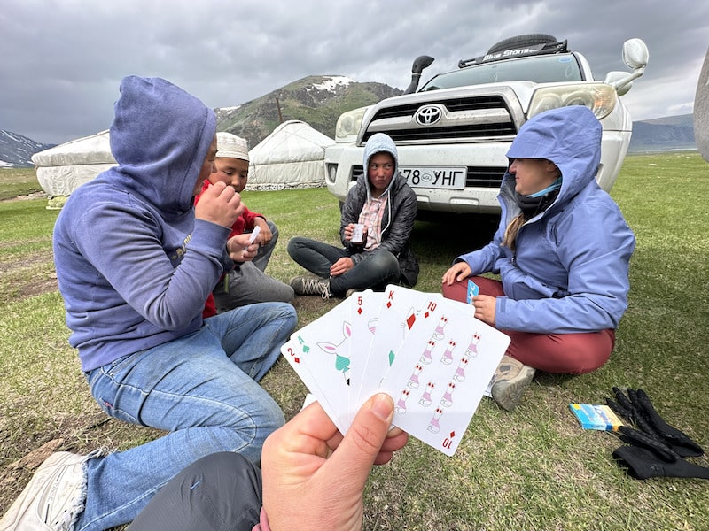 traveler playing cards at their Altai Mountain homestay in Mongolia