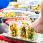 couple staying at a vegan resort in the US getting meat-free food from the buffet line