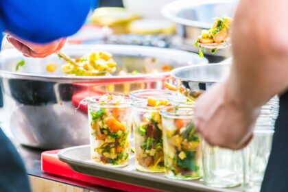 couple staying at a vegan resort in the US getting meat-free food from the buffet line