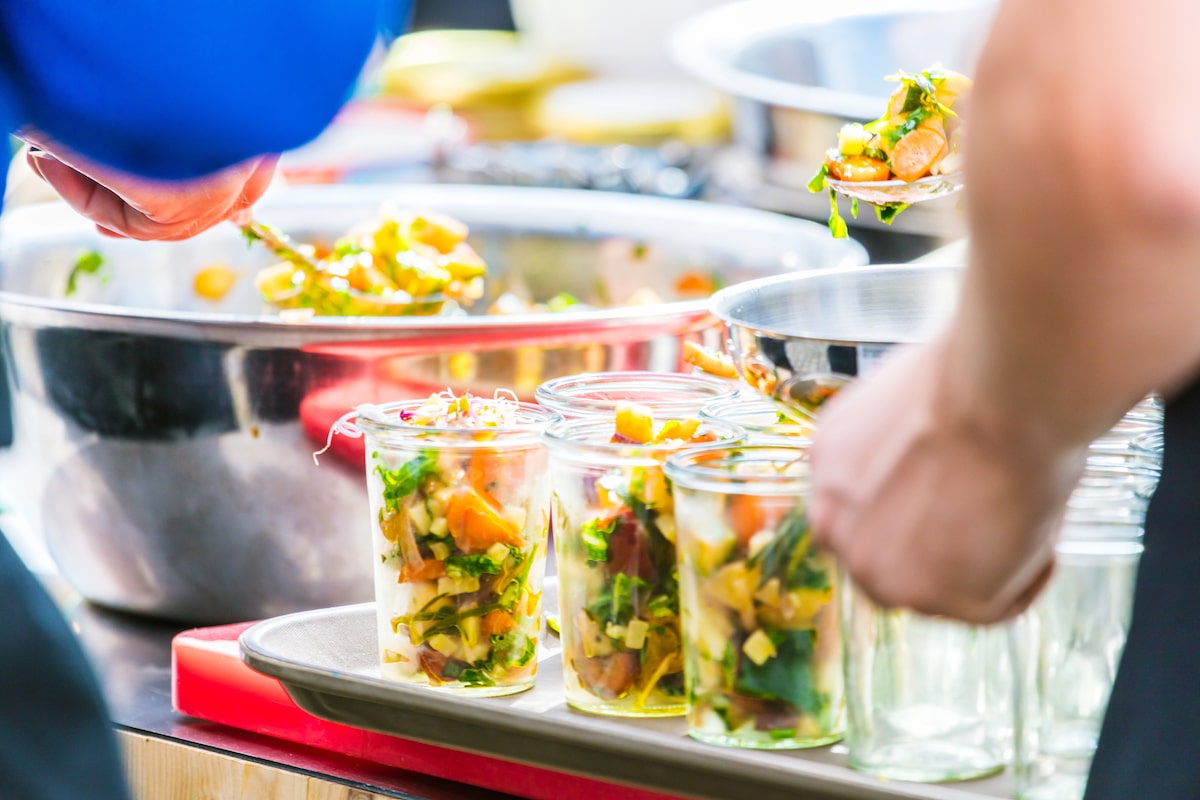 couple staying at a vegan resort in the US getting meat-free food from the buffet line