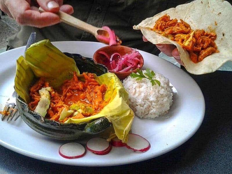 Trying Cochinita pibil is a top way to explore Mexican culture food in Yucatan
