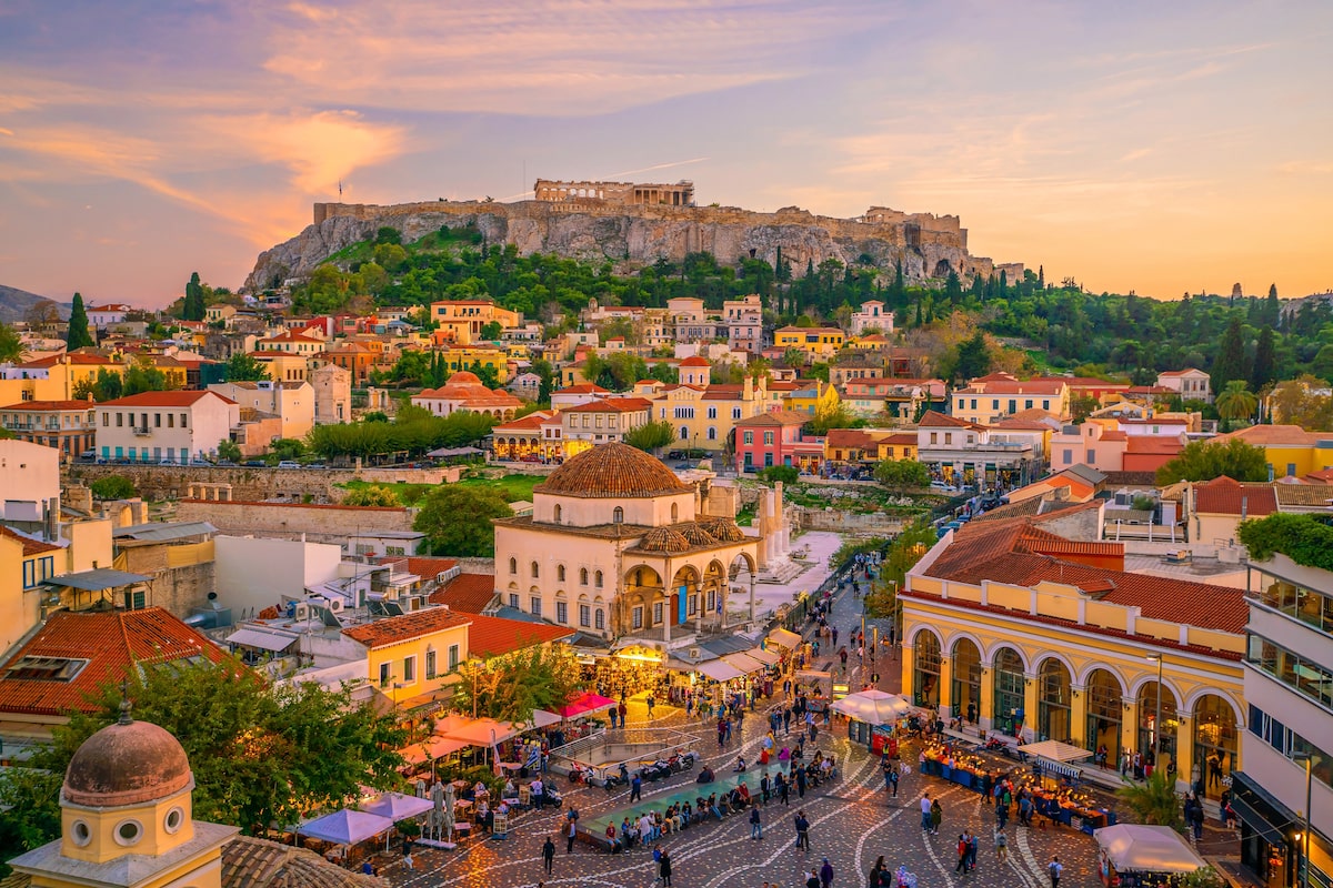 Downtown Athens city skyline at sunset with The Acropolis and the Parthenon Temple in view from Monastiraki Square
