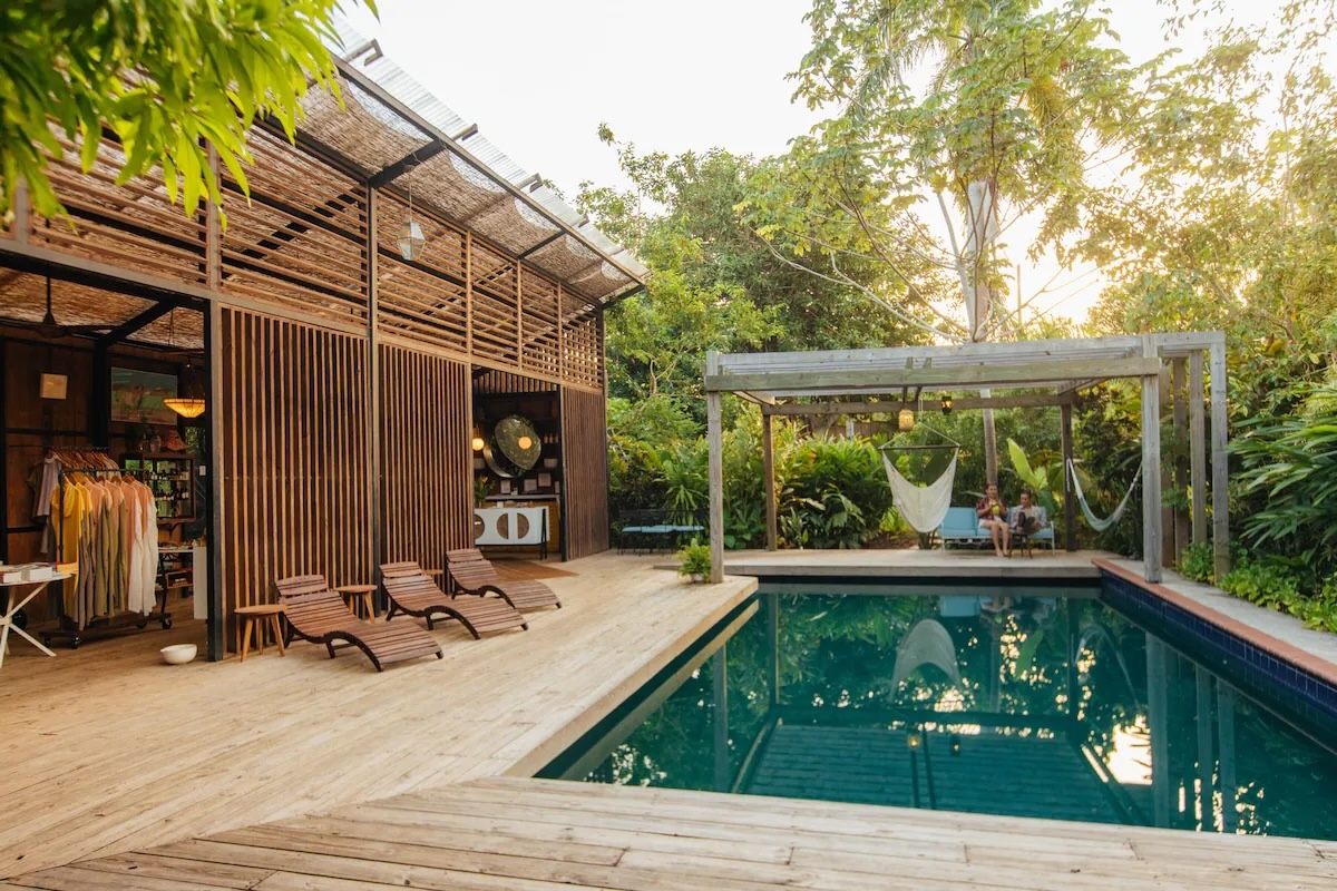 Outdoor pool area at Finca Victoria in Vieques, Puerto Rico, surrounded by lush greenery and wooden lounge chairs.