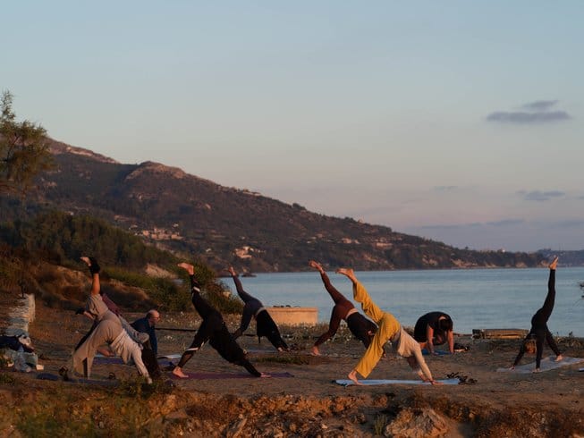 People doing yoga on one of the top vegan yoga retreats in Greece