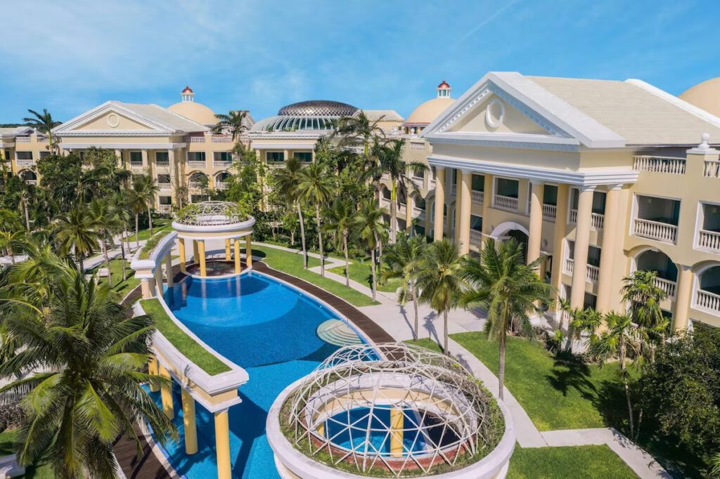 pool surrounded by yellow hotel rooms at the Iberostar Grand Paraíso vegan resort in Mexico