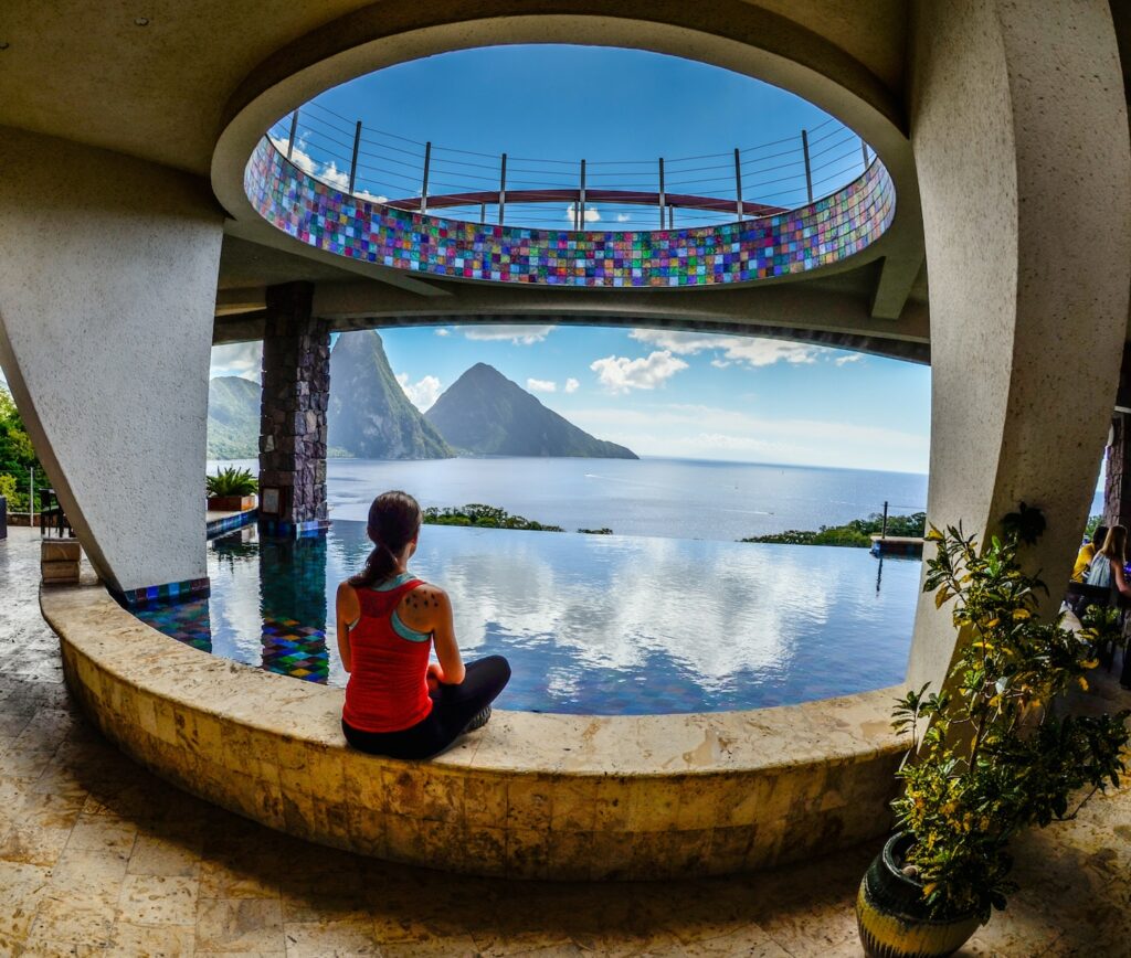 traveler gazing out at the Pitons (volcanic mountains) from Jade Mountain vegan resort in St. Lucia