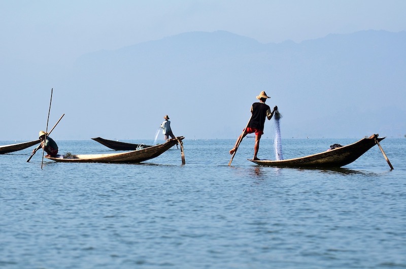 fishermen on small wooden boats on Inle Lake in Myanmar