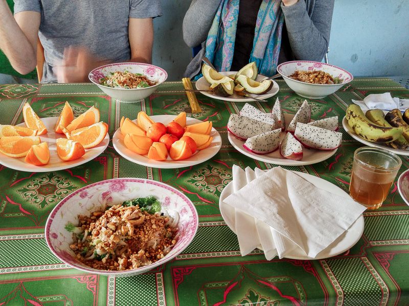 table of fresh fruit including oranges, dragon fruit, and bananas