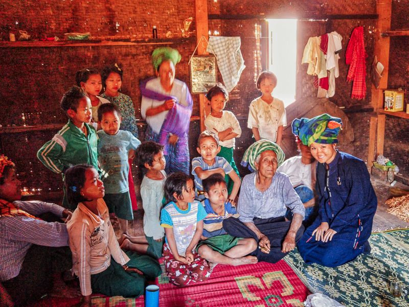 travelers visiting a local family in Myanmar while trekking from Kalaw to Inle Lake
