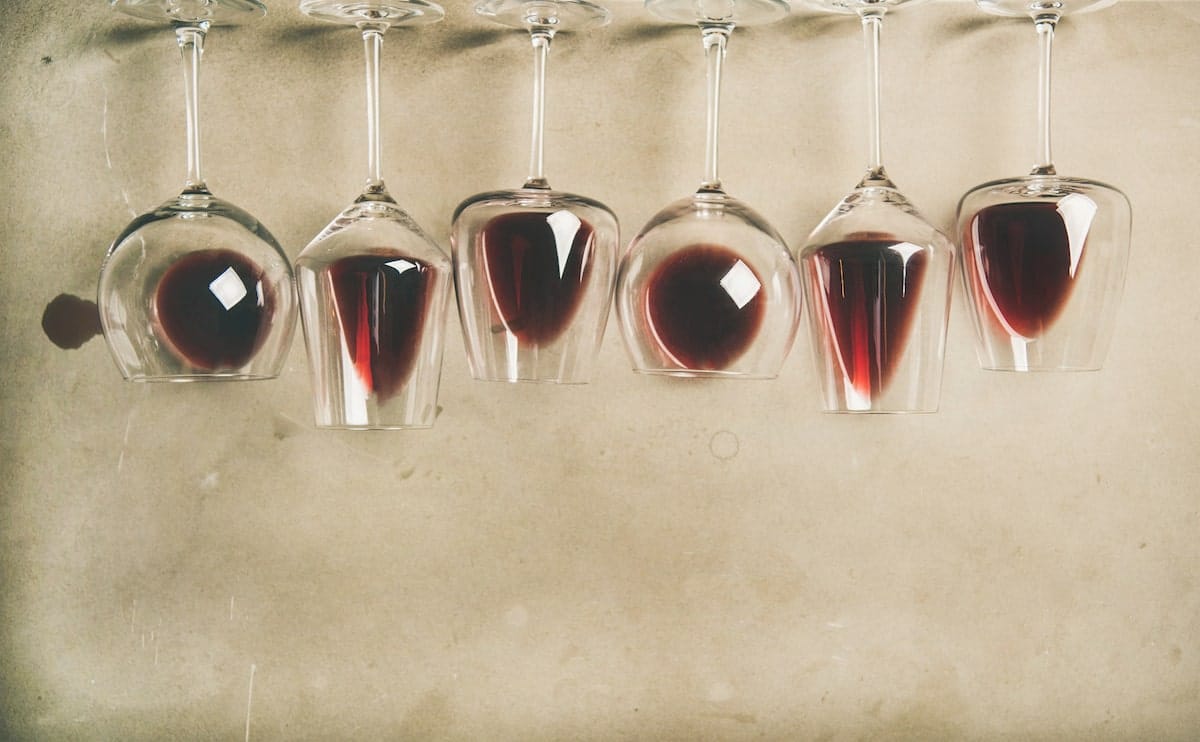 a selection of red wines in different types of glasswear meant for pairing with a food tasting menu