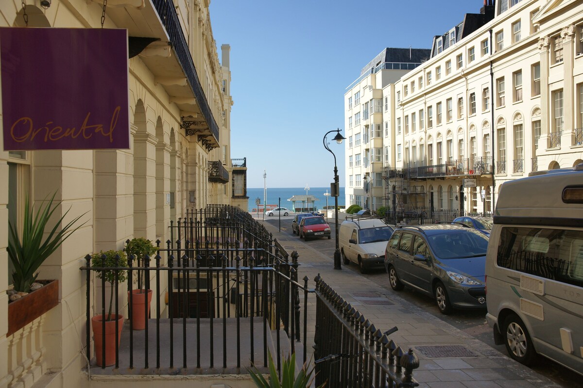 exterior of the Orential Hotel with Brighton's waterfront in the background