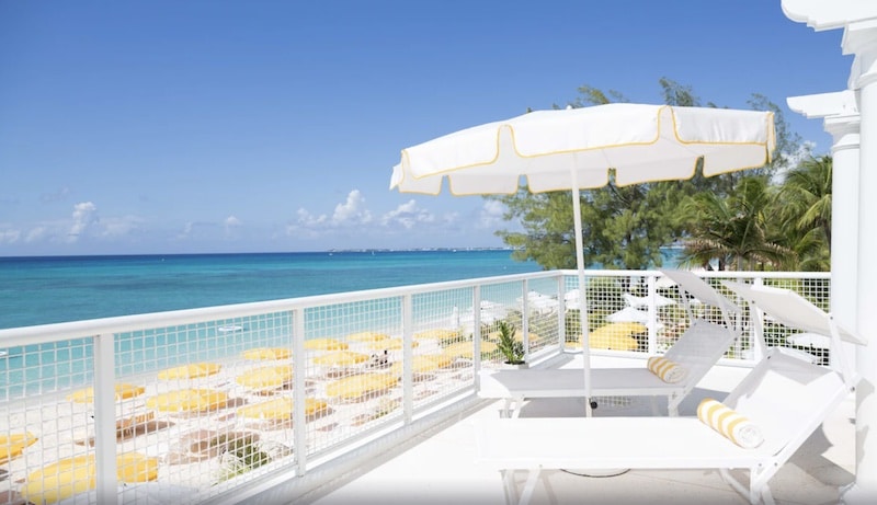 terrace with lounge chairs at the vegan-friendly Palm Heights Resort in the Caribbean
