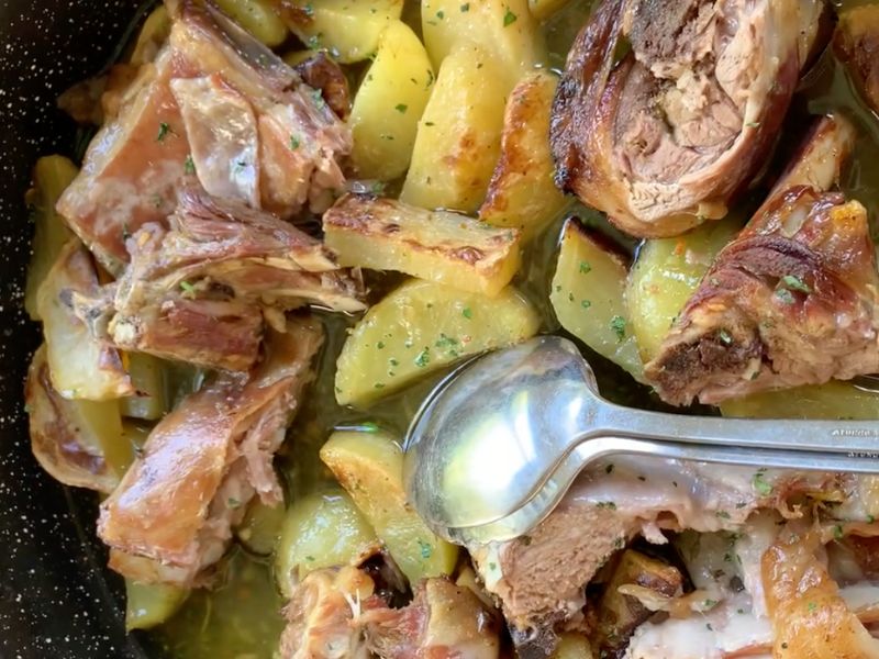 A close up image of a lamb and potato Peka dish