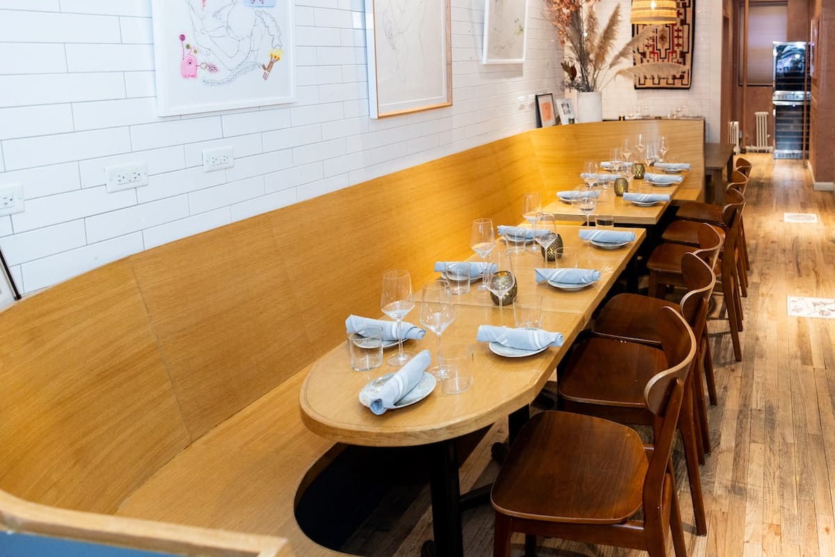 table set up with fancy plates and glassware for a tasting event at The Ruffian NYC