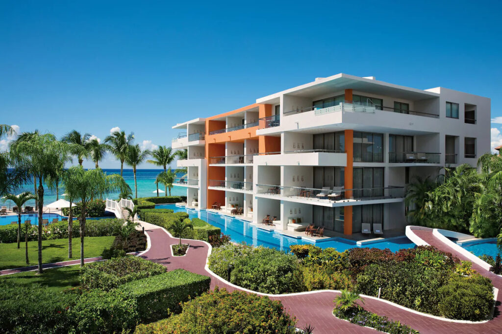 accommodation surrounded by a pool at the Secrets Aura vegan-friendly hotel in Mexico