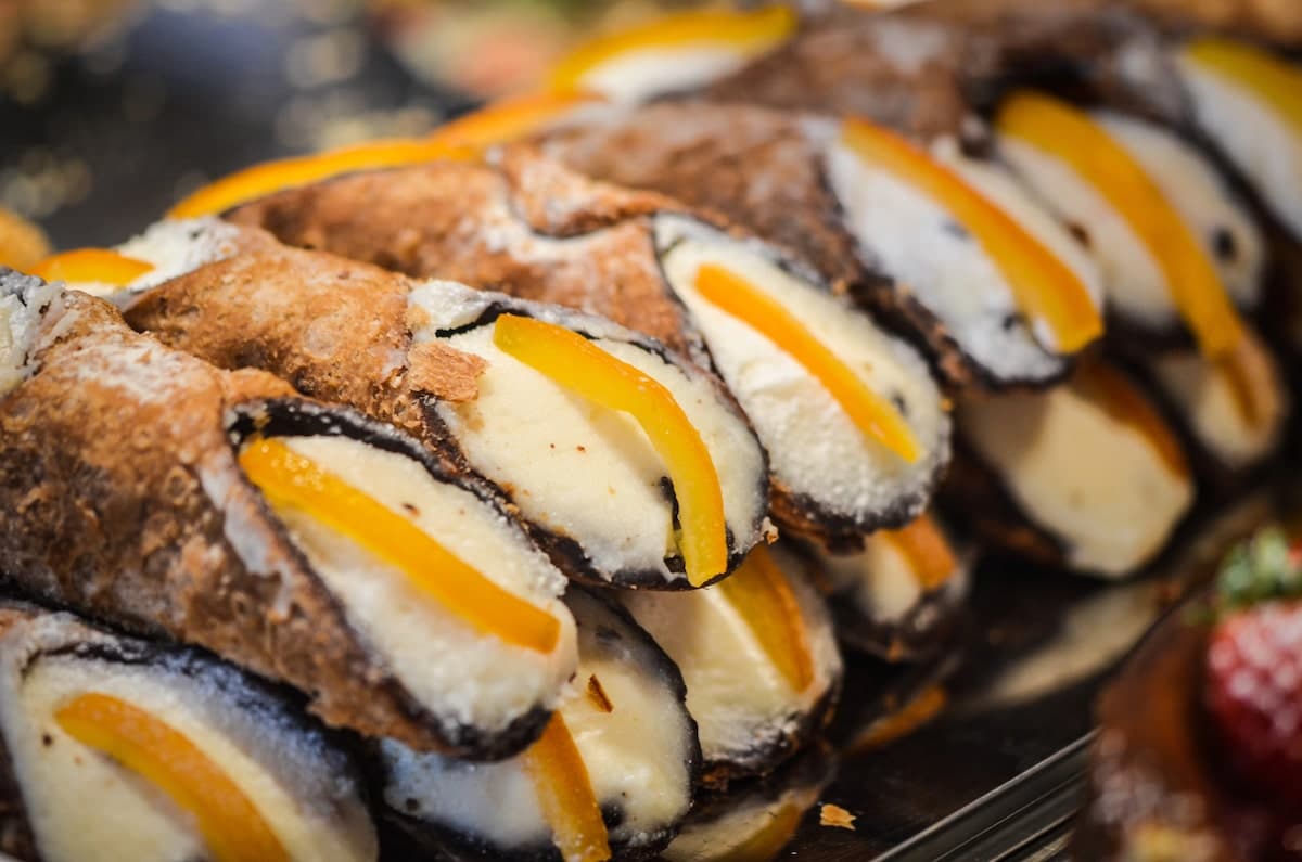 Sicilian cannolis with dried fruit on a bakery rack