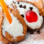 a plate of 3 Sicilian cannolis in different flavor variations