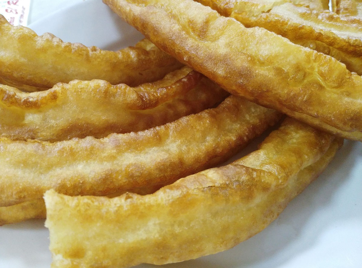 Spanish churros, a vegan-friendly dessert featuring crispy, fried dough pastries.