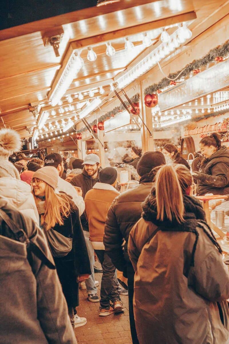 A group of people in Strasbourg Christmas Market.