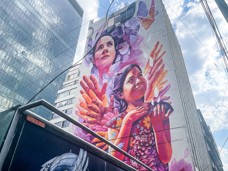 giant Mexico City mural depicting two women surrounded by butterflies