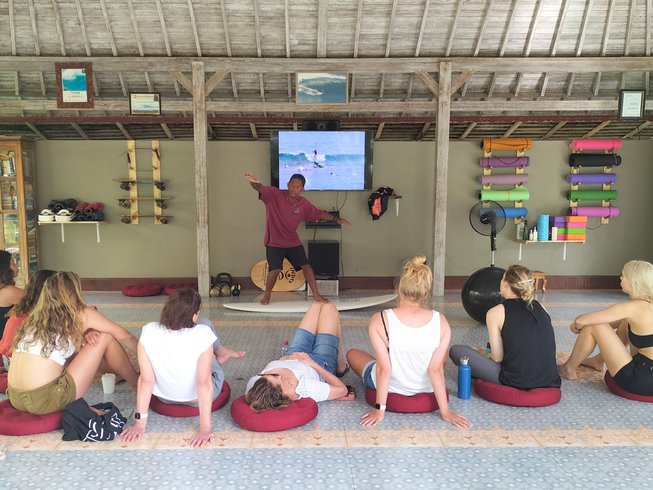 group of women getting a surf lesson during a Bali yoga and surf retreat