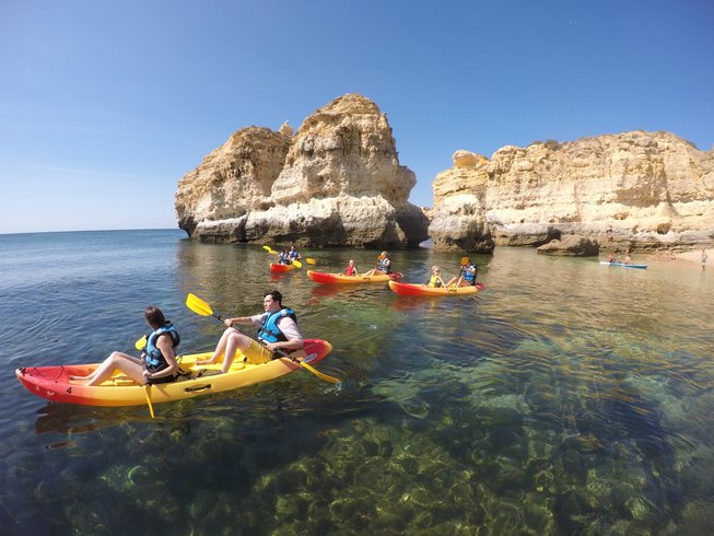 people kayaking over crystal clear water