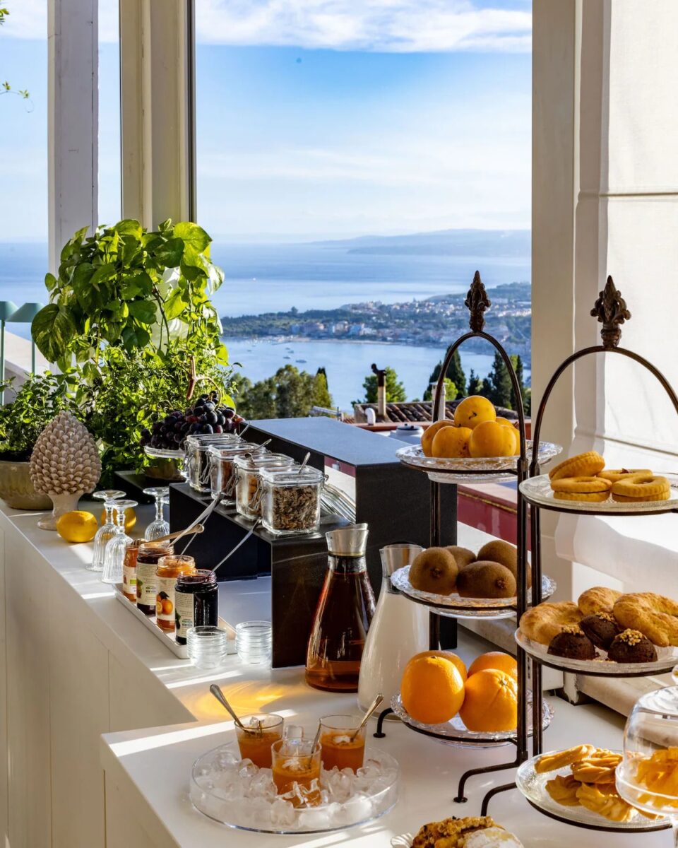 The free daily vegan buffet breakfast of fruits, breads, and jams at Hotel Taodomus in Italy overlooking the water