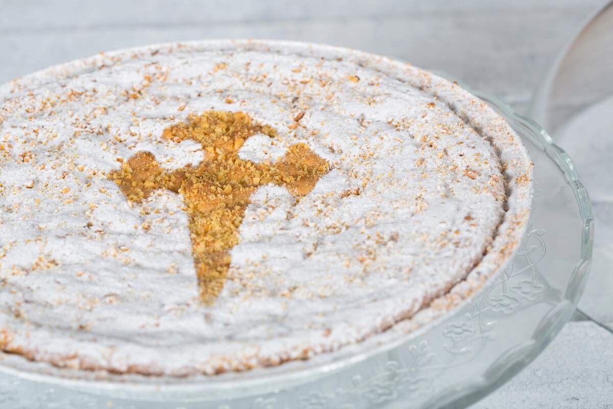 Tarta de Santiago, a traditional Spanish dessert cake made with ground almonds and decorated with powdered sugar and a cross design.