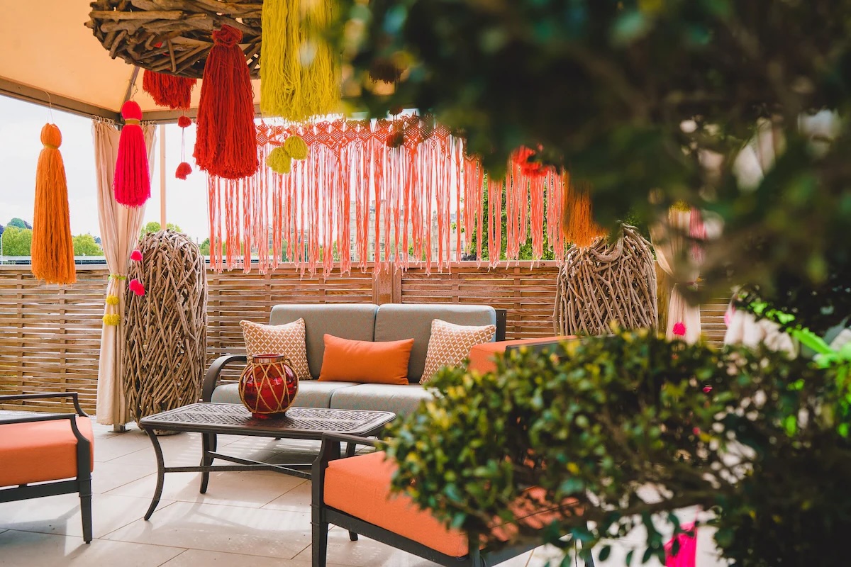 Charming garden view of The Bird vegan hotel in the UK with colorful and inviting outdoor seating.