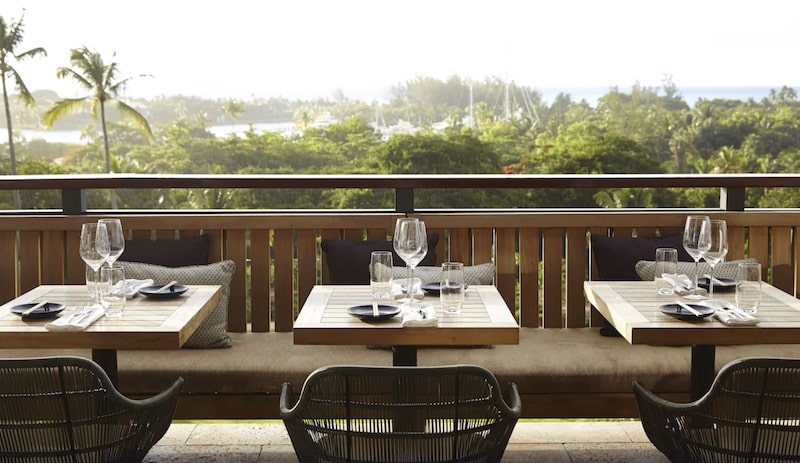 traveler eating a vegan meal with a waterfront view at Island House in the Bahamas, Caribbean