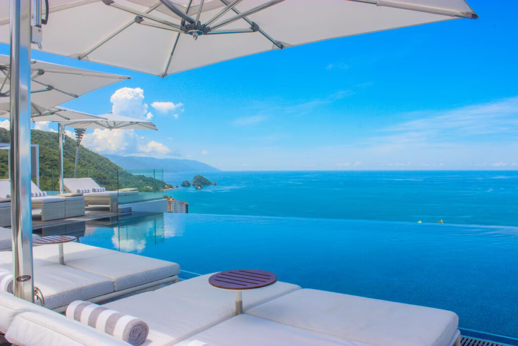 pool lounge chairs overlooking the water at the vegan-friendly Mexican Hotel Mousai