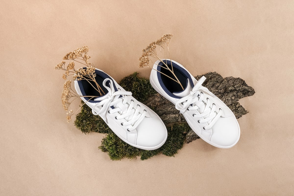 pair of white vegan shoes being sold as a store in Brighton