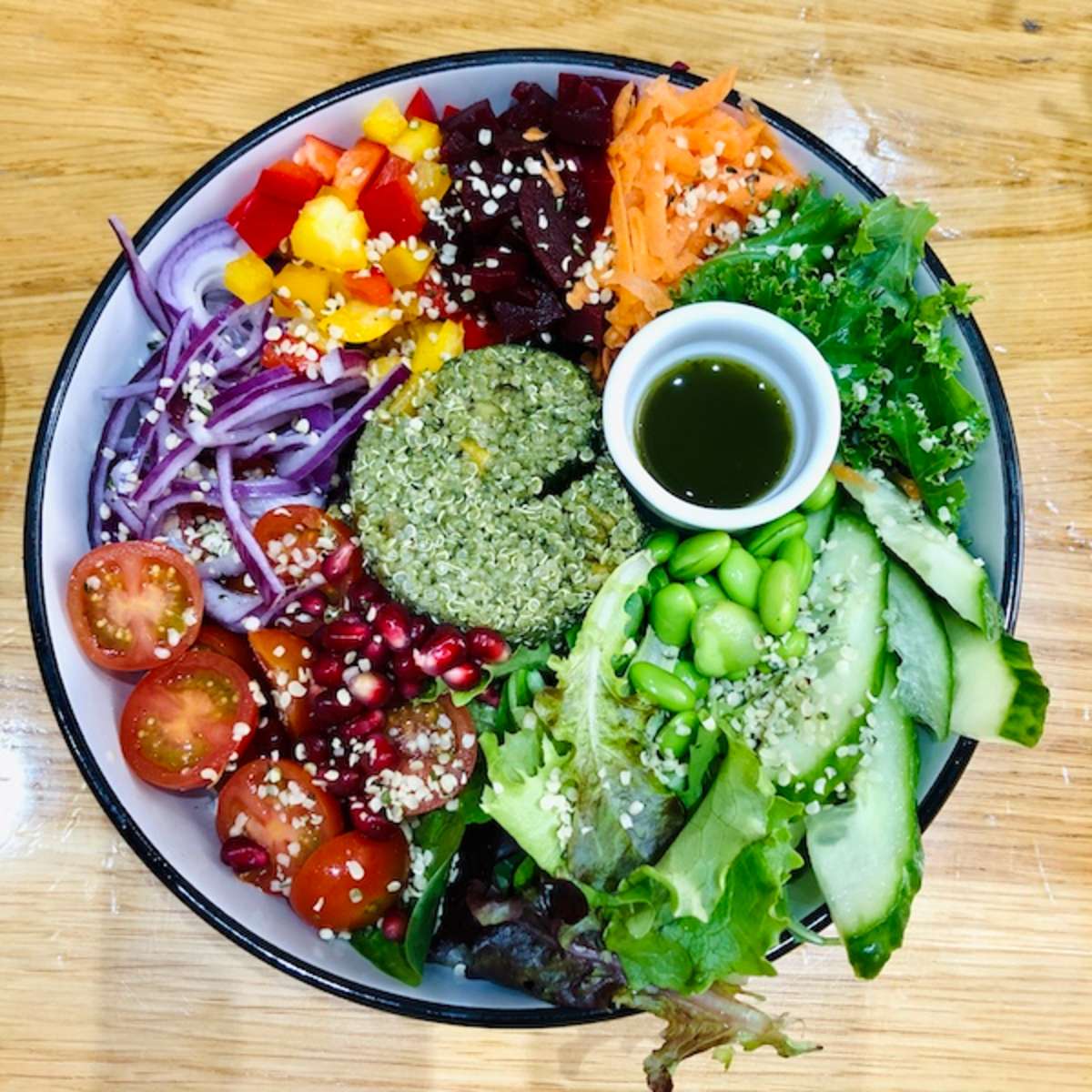 bright salad with lettuce, tomatoes, cucumbers, and carrots from a vegan restaurant in Brighton