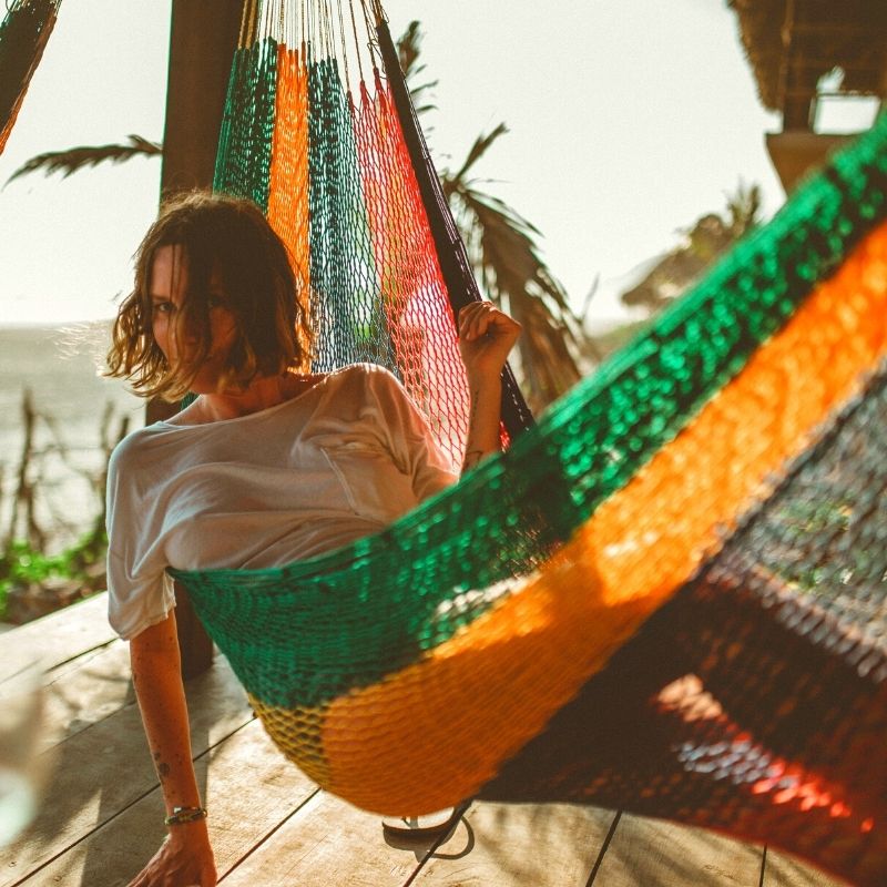 Woman in a colorful hammock during a silent retreat in mexico