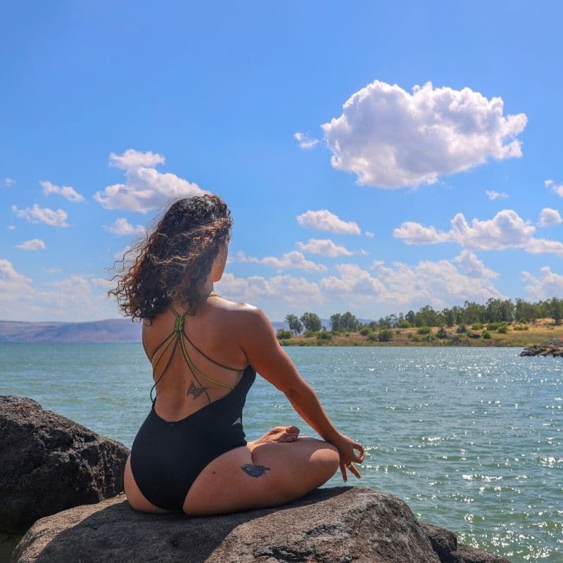 Woman meditating in mexico on a rock 