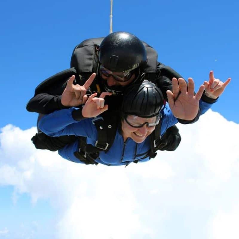 Woman skydiving tandem with male instructor