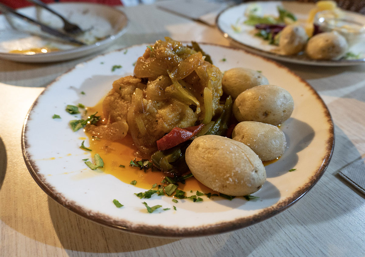 Papas Arrugadas, a Spanish vegan dish featuring wrinkled potatoes served with a savory vegetable sauce.