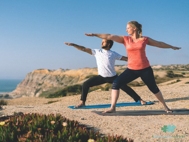 people doing beach yoga on a yoga hiking retreat in Santa Cruz, Portugal