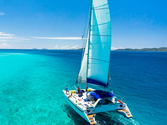 sailboat cruising over turquoise waters during a Mallorca yoga retreat